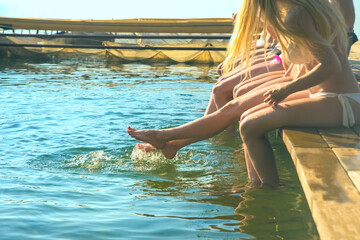 group of happy young woman feet splash water in sea and spraying at the beach on beautiful summer...