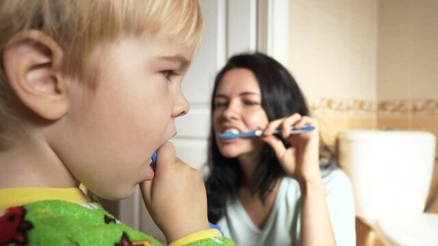 Mother and Son Brush Teeth in Bathroom in Morning After Sleep. 2x Slow motion - 60FPS