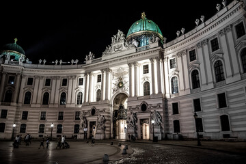 Fototapeta na wymiar Illuminated Entrance Portal To Imperial Residence Hofburg In The Inner City Of Vienna In Austria