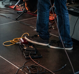 Playing guitar. In a studio. Musical instrument. At the rehearsal. Effects Pedal. Electric bass...