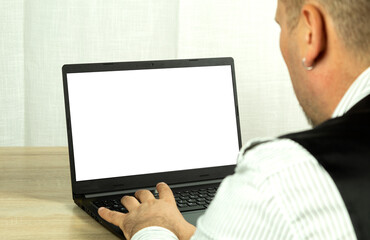 A man looks into a computer monitor