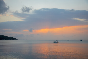 A Sailing Boat with Misty Sunset and Reflection on Water