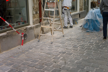 a worker renovating facade