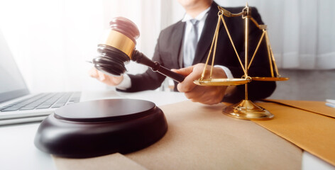 Business and lawyers discussing contract papers with brass scale on desk in office. Law, legal services, advice, justice and law concept picture with film grain effect