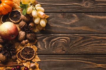 top view of autumnal harvest and decoration on brown wooden background