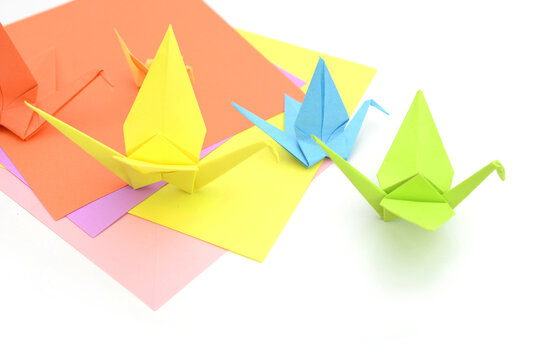 origami birds from colored papers on white background