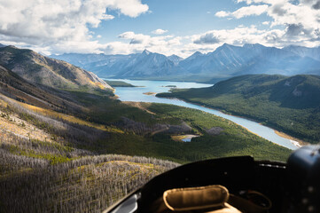 Aerial view from helicopter of Rocky mountains with turquoise lake and blue sky at Banff national park - Powered by Adobe