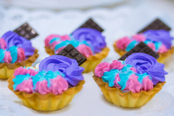 Assortment of delicious fresh shortcrust tart cakes with cream and chocolate for sale on white plate at cuisine of restaurant, cafe. Dessert, culinary, sweet food and confectionery concept