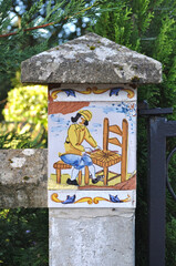 Close Up of Gate Post with Colourful Ceramic Tile Decoration 