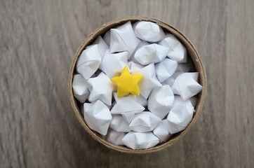 White origami stars with yellow star in box