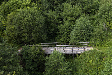 wooden bridge over the river in the forest