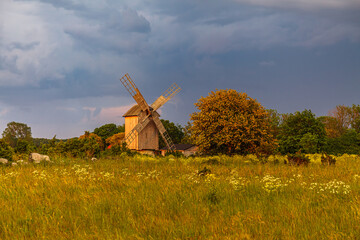 Dutch style wooden windmill at sunset