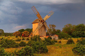 Fototapeta na wymiar Dutch style wooden windmill at sunset