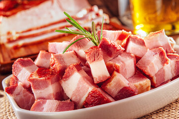 Fresh cubes of bacon with rosemary branch