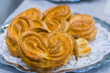 Freshly baked heart shaped buns on plate at cuisine of restaurant, bakery. Professional cooking, catering, culinary, bakery, gastronomy and food concept