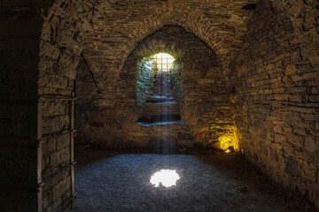 Rays of light shining into the medieval cellar