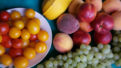 Nectarines, pears, peaches, green grapes,tomatoes, zucchini close-up.