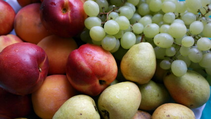 Naklejka na ściany i meble Nectarines, pears, peaches, green grapes close-up.