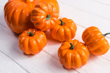 decorative pumpkins on white wooden background