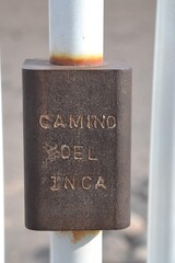 Camino Del Inca (Inca trail) hiking trail to Machu Picchu marked with engraved pole.