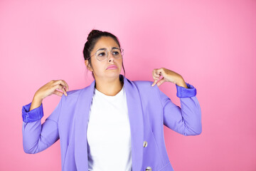 Young beautiful business woman over isolated pink background with a successful expression