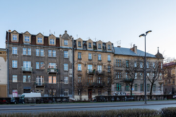 Facades of residential old buildings with beautiful molding and balconies on Krakow street, Poland