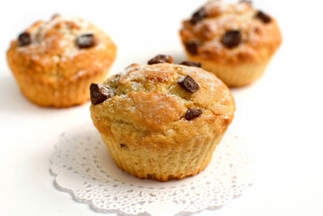 Close-up of homemade cupcakes with chocolate chips on a white