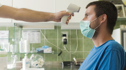 Measuring temperature for coronavirus infection with face mask.