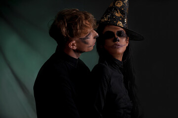 Halloween celebration and party. Halloween couple. Dark background. 