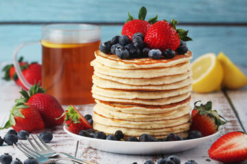 A stack if home-made pancakes with berry	