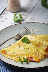 Omelette with ham and cheese on the plate