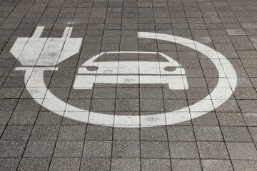 Electric car sign on road. Pictogram at the parking place. Car charging icon.