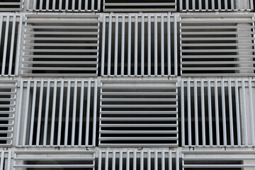 Geometric pattern background. Modern facade surface. Air ventilation at the parking lot.