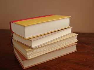 a stack of books on a table, close up