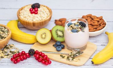 Group Fruits Breakfast with bread Whole grains and nuts, yogurt mix with Cherry , banana, avocado in the wooden table. Breakfast for Health and Diet concept
