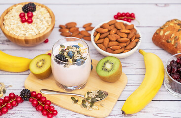 Obraz na płótnie Canvas Group Fruits Breakfast with bread Whole grains and nuts, yogurt mix with Cherry , banana, avocado in the wooden table. Breakfast for Health and Diet concept