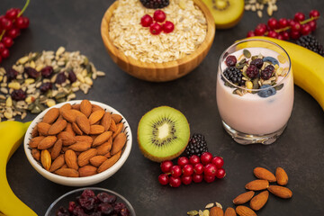 Group Fruits Breakfast with bread Whole grains and nuts, yogurt mix with Cherry , banana, avocado in the wooden table. Breakfast for Health and Diet concept
