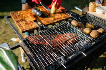 Concept of the correct cooking of meat. The chef prepares, fries a beef steak in the open air. Raw fresh steak served with pepper and salt.