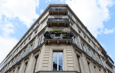 Traditional French house with typical balconies and windows. Paris.