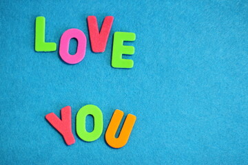 Love, love you lettering by colorful letters, textured background 