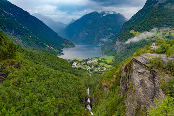 Scenic view of the Geiranger Fjord, Norway. A spectacular, narrow finger of the Sunnylvsfjorden, a branch of the Storfjorden. Geiranger village is located at the end of the fjord