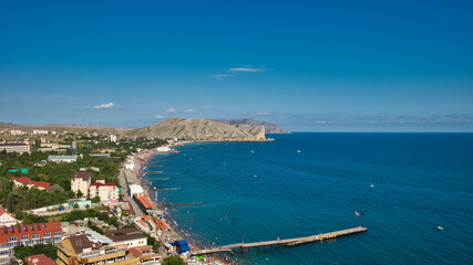 Naklejka na ściany i meble The Sudak Bay at summer, Crimea. The crowds of people on the beach.