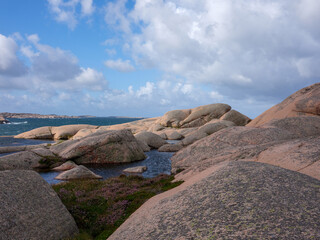 Fototapeta na wymiar Rolling granite hills with ocean background