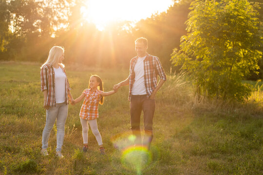 Happy family on sunset in nature