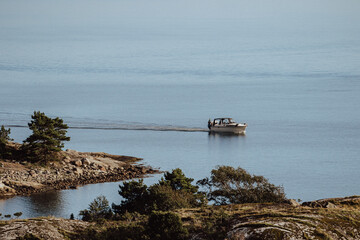 Fototapeta na wymiar Boat on the ocean with rocky islands