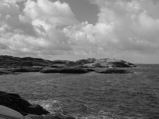 Coastline in Sweden with granite rocks and weathered cliffs in a monochrome photograph