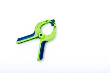 blue and green lastic clamp on a white isolated background