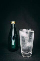 glass with ice and bottle of water 