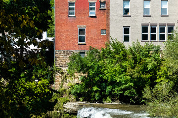 Old Brick Buildings Near Tree Laden River