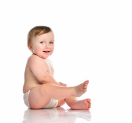 Beautiful naked baby boy posing isolated in white background.